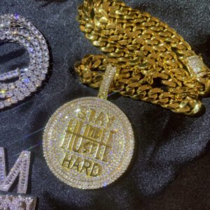 Gold pendant paired with Cuban link chain, luxury hip hop necklace.