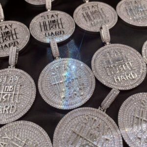 Collection of white iced out coin pendants, showcasing the beauty and craftsmanship of this elegant hip hop necklace.