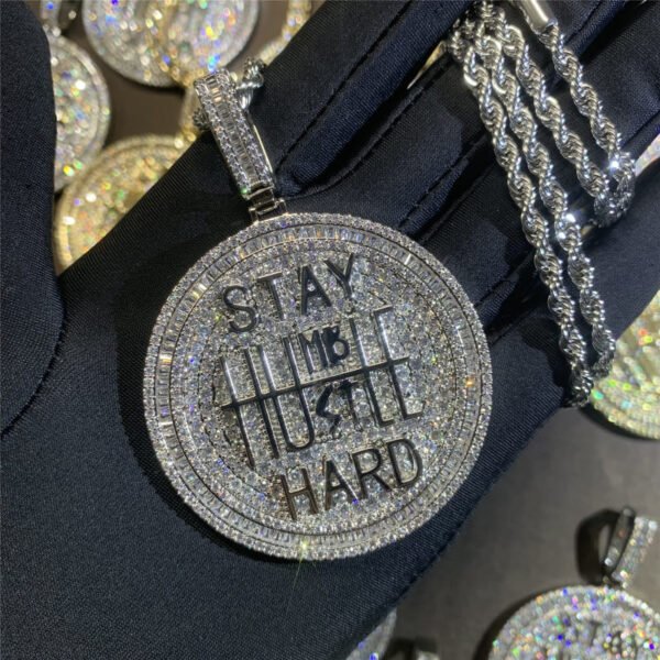 White pendant held in hand, bling jewelry for hip hop lovers, men’s necklace.